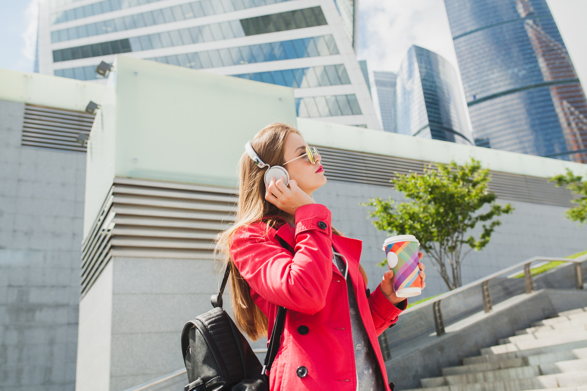 Girl listening to music while having a coffee drink in Toronto Ontario displaying the possible lifestyle in Toronto