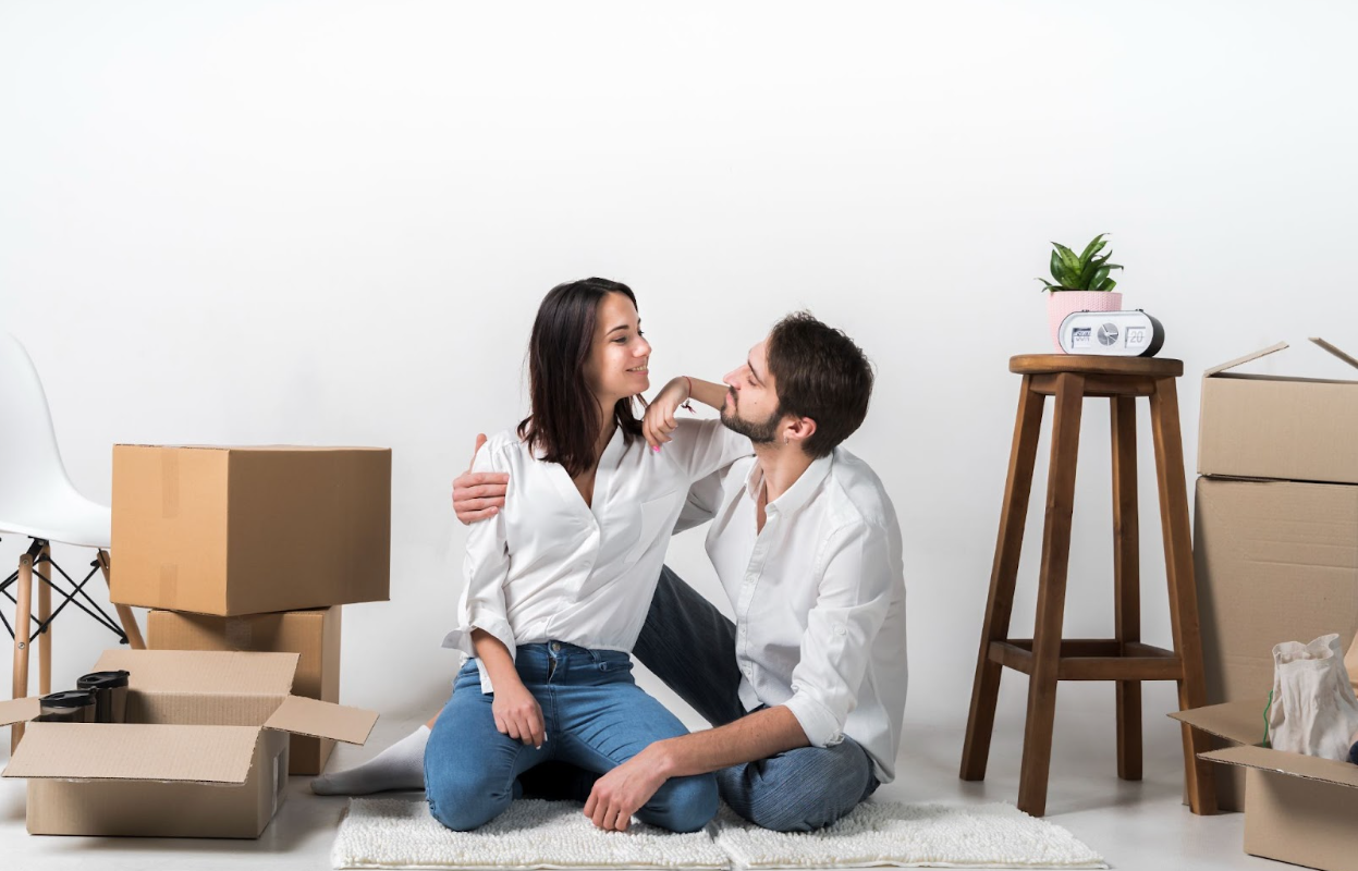 Ontario Rebate Couple sitting down in their new home after buying their home because of the new ontario rebate
