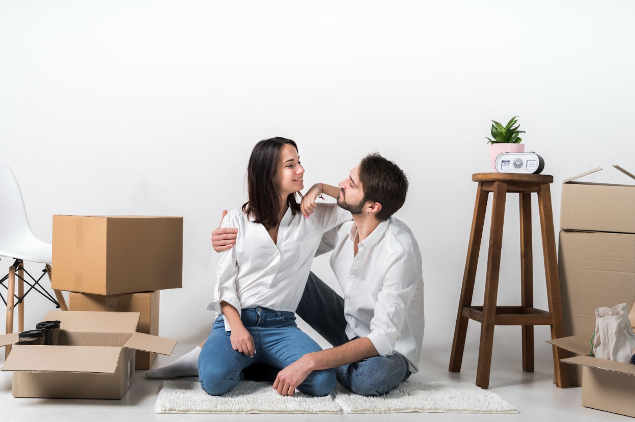 Ontario Rebate Couple sitting down in their new home after buying their home because of the new ontario rebate